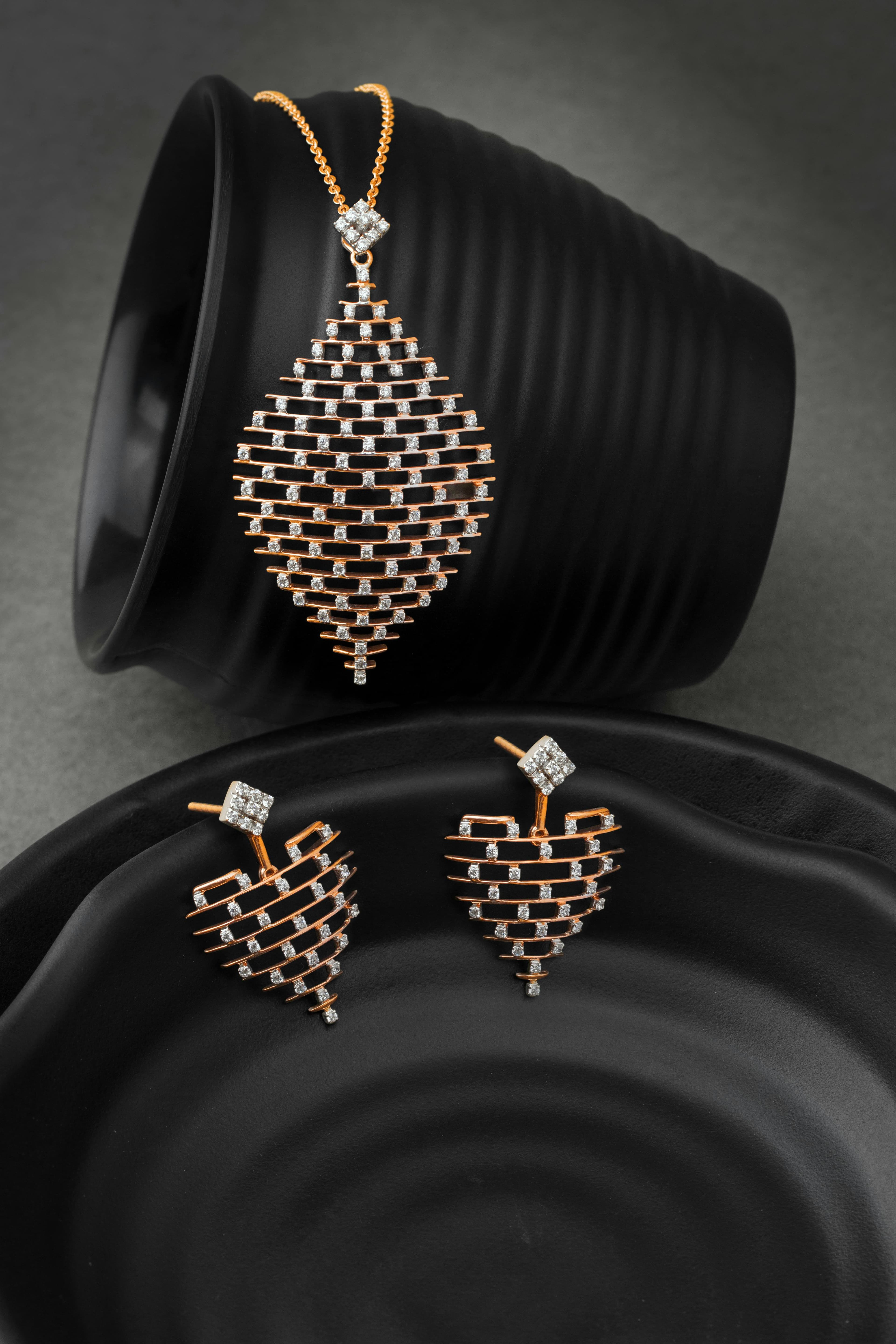 Pearl stud earrings displayed on a warm jewelry surface