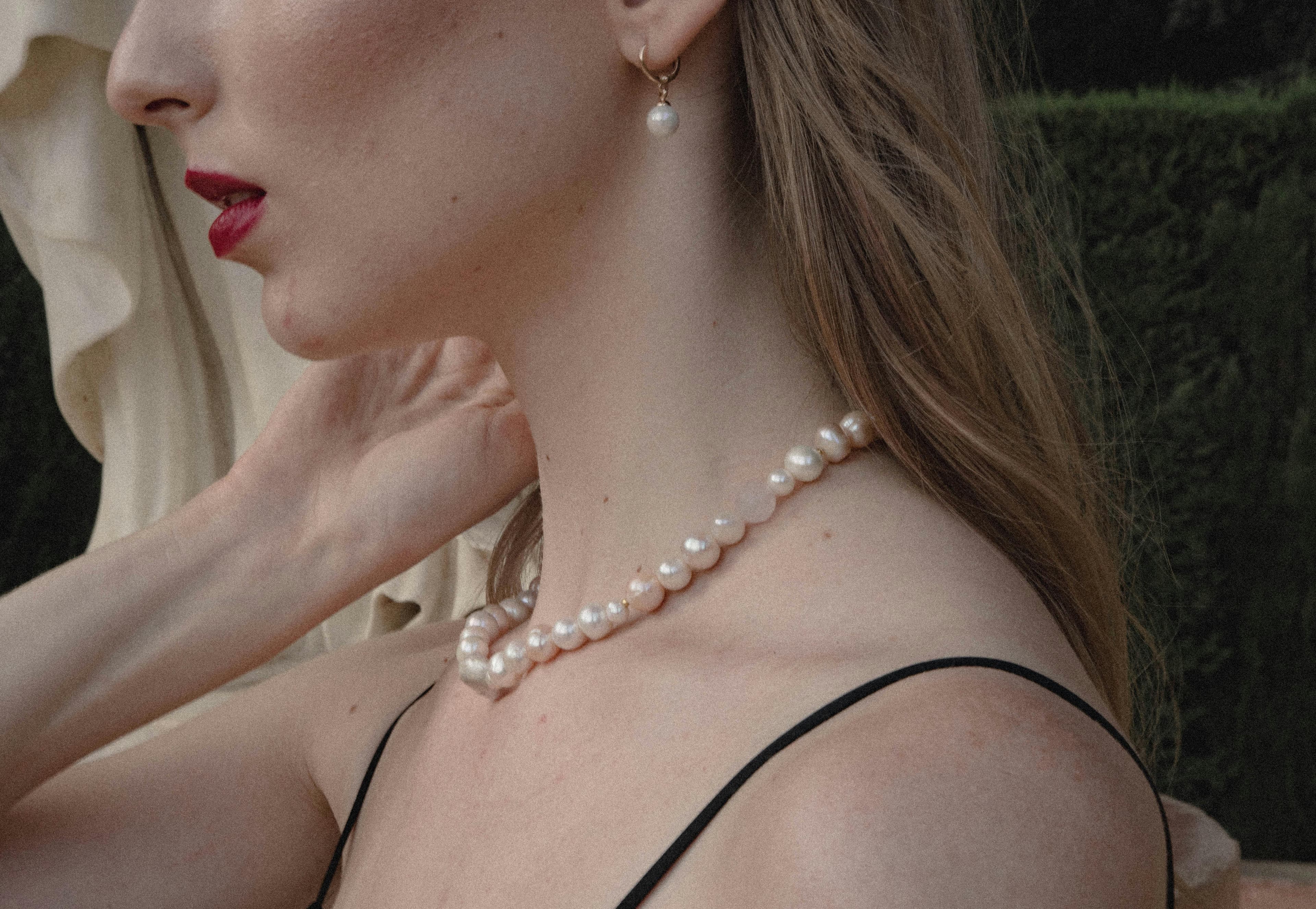 Model wearing a refined pearl necklace